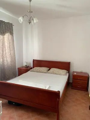 a bedroom with a large bed with white sheets at Apartments Boffi in Ulcinj
