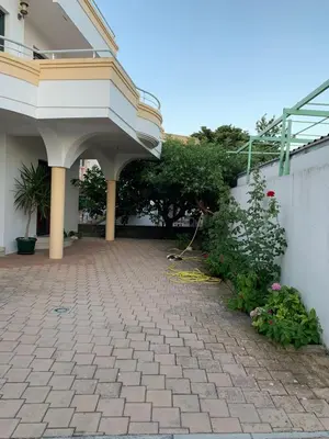a courtyard of a house with a building at Apartments Boffi in Ulcinj