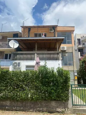 a building with an umbrella sitting on the balcony at Apartman Ema in Sutomore