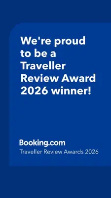 a blue sign that says were proud to be a traveller reviewagency winner at Una apartmani Petrovac in Petrovac na Moru