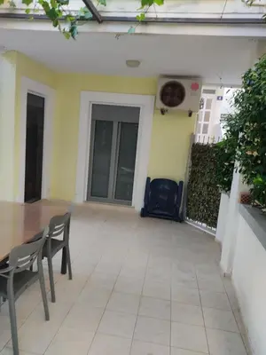 a patio with chairs and a table in a house at Una apartmani Petrovac in Petrovac na Moru