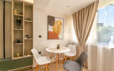 a small dining room with a table and chairs at ELIT APARTMENTS Budva in Budva