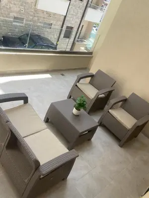 a room with three chairs and a potted plant at Anja Apartment in Becici