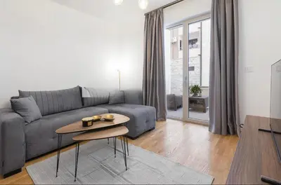 a living room with a couch and a table at Anja Apartment in Becici