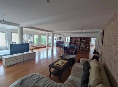 a living room with a couch and a tv at Fun and spacious apartment in Budva
