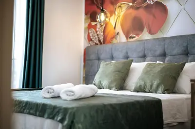 a bedroom with a bed with towels on it at M&N Holiday Resort in Ulcinj