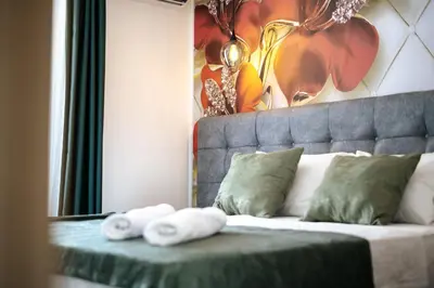 a bedroom with a bed with towels on it at M&N Holiday Resort in Ulcinj