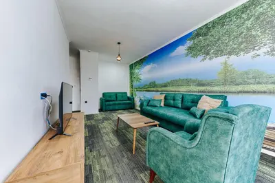 a living room with a large painting on the wall at M&N Holiday Resort in Ulcinj