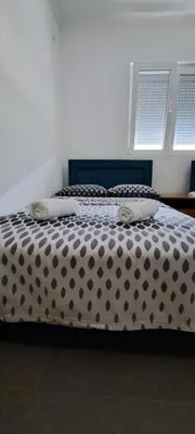 a bed with a polka dot blanket and two pillows at Family house VND in Kotor
