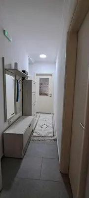 a room with a hallway with a kitchen with a door at Family house VND in Kotor