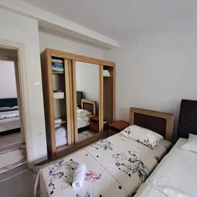 a bedroom with a bed and a mirror at Family house VND in Kotor