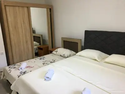a bedroom with two beds and a large mirror at Family house VND in Kotor