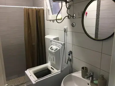 a small bathroom with a sink and a mirror at Family house VND in Kotor