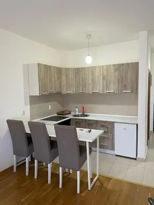 a kitchen with a table and chairs and a counter at Studio Marovic in Ulcinj