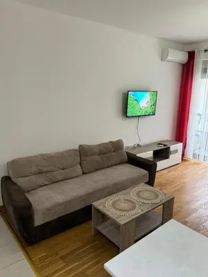 a living room with a couch and a flat screen tv at Studio Marovic in Ulcinj
