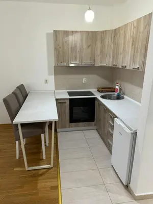 a small kitchen with a table and a sink at Studio Marovic in Ulcinj