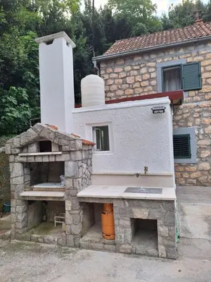 a building with a stone oven in front of it at Old stone house Danka in Kotor