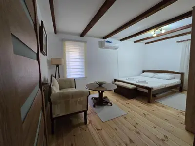 a room with a bed and a chair and a table at Old stone house Danka in Kotor