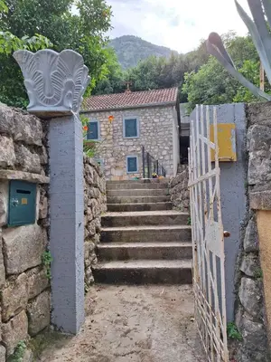 a set of stairs with a gate and a building at Old stone house Danka in Kotor