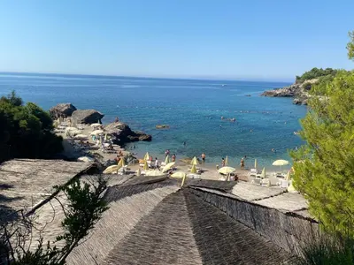 a view of a beach with people in the water at Deskos Cottage in Sutomore in Zgrada