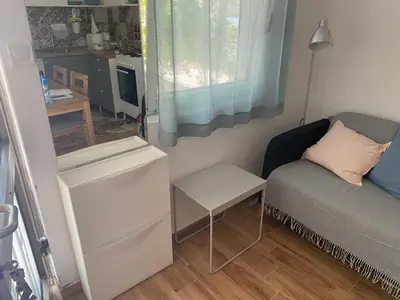 a small living room with a couch and a table at Deskos Cottage in Sutomore in Zgrada