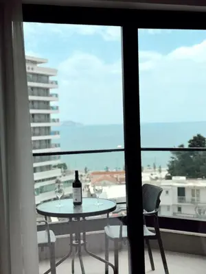 a table with a bottle of wine sitting on a balcony at Blue Sutomore in Brca