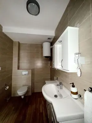 a bathroom with a white sink and a toilet at Blue Sutomore in Brca