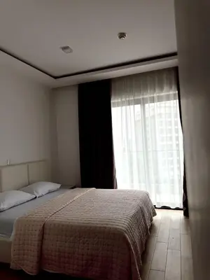 a bedroom with a bed and a large window at Blue Sutomore in Brca