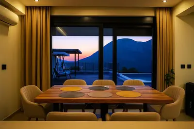 a dining room table with chairs and a view of a mountain at Villa Monza in Bar