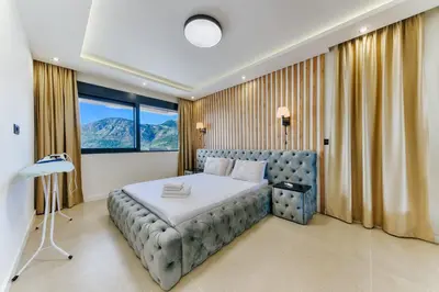 a bedroom with a bed and a large window at Villa Monza in Bar