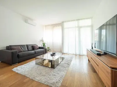 a living room with a couch and a glass coffee table at Classy Two-Bedroom Apartment in Budva