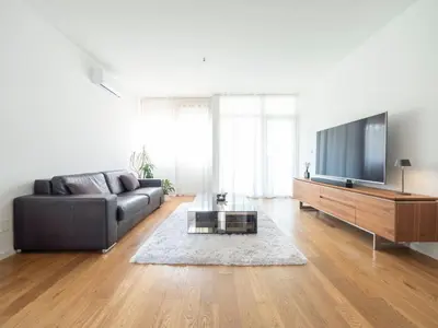 a living room with a couch and a flat screen tv at Classy Two-Bedroom Apartment in Budva