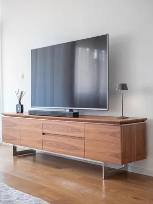 a large flat screen tv on a wooden entertainment center at Classy Two-Bedroom Apartment in Budva