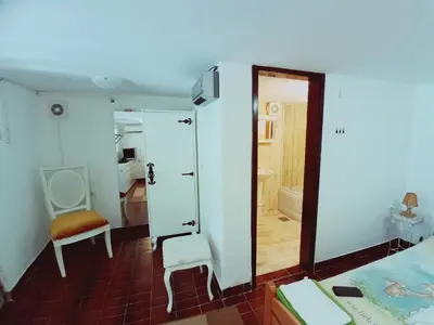 a bedroom with a mirror and a bed and a chair at Zagradge IN Apartments in Zagrađe
