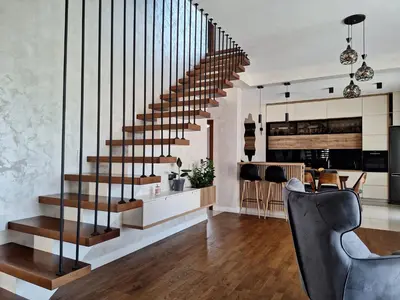 a staircase in a living room with a table and chairs at Villa Bartula Lux in Rap