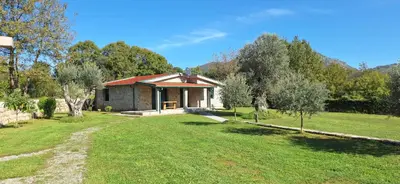 a small house in the middle of a field at Rustic Cottage Montenegro Bridje in Podgorica