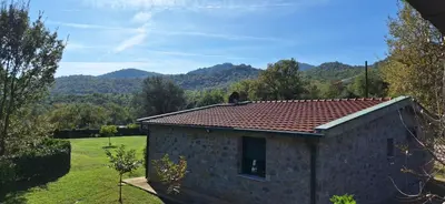a small building with a view of a mountain at Rustic Cottage Montenegro Bridje in Podgorica