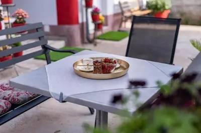a table with a plate of food on top of it at Apartmani Kaan in Podgorica