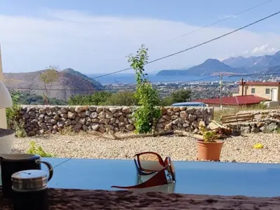 a house with a swimming pool and a stone wall at Studios Panoramablick Bar in Bar