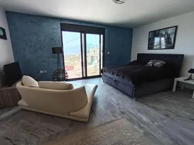 a bedroom with a bed and a couch and a chair at Studios Panoramablick Bar in Bar