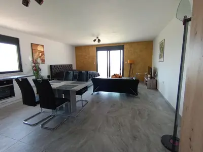 a living room with a table and chairs and a couch at Studios Panoramablick Bar in Bar