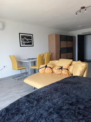 a room with a couch and chairs and a table at Studios Panoramablick Bar in Bar