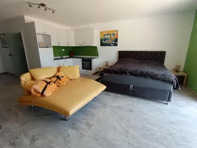 a living room with a bed and a couch at Studios Panoramablick Bar in Bar