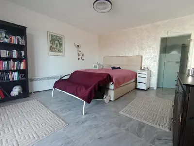 a bedroom with a bed with a red blanket and a mirror at Studios Panoramablick Bar in Bar