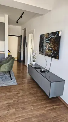 a living room with a coffee table and a chair at Podgorica apartments Planet in Podgorica