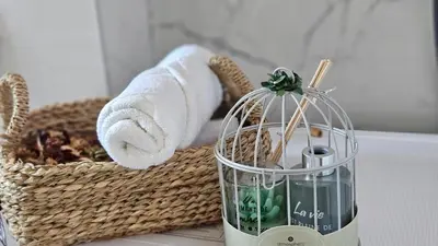 a basket of towels and a towel dispenser next to a basket of towels at Podgorica apartments Planet in Podgorica
