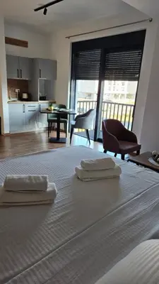 a bedroom with a bed with two towels on it at Podgorica apartments Planet in Podgorica