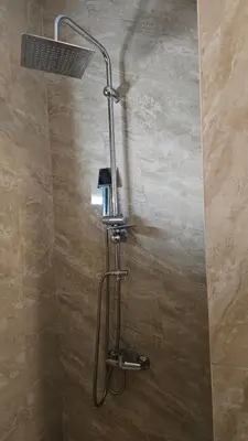a shower with a shower head in a bathroom at Podgorica apartments Planet in Podgorica