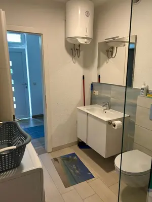 a bathroom with a sink and a toilet at Apartments David in Ulcinj