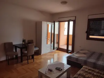 a living room with a couch and a table at Studio Vanja in Budva